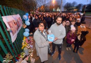 Parents Arathi Nehar, front left, and Jaswinder Singh, front right, attended a vigil last year