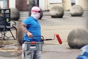 Two men wearing St George's masks have been captured on camera painting England flags on roundabouts and zebra crossings across a town.  