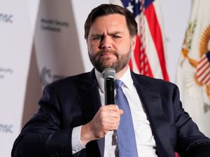 US Vice President JD Vance holding a microphone