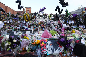 Floral tributes left at the Black Sabbath Bridge bench on Broad Street in Birmingham