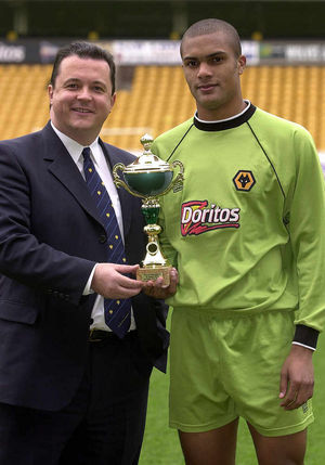 Presented with a youth team trophy by Jez Moxey in 2003