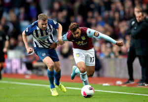 Aston Villa's Trezeguet (right) and Brighton and Hove Albion's Adam Webster (left) battle for the ball