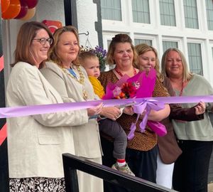 The Lord Mayor of Coventry, Councillor Rachel Lancaster, cutting the ribbon to reopen the newly furbished Partou Wonder Years Day Nursery and Pre-school in Coventry