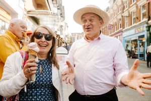 Sir Ed Davey hands ice creams to passers-by and supporters.