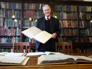 NI Secretary Hilary Benn views a vintage edition of The News Letter