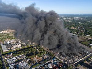A massive cloud of black smoke over a shopping centre