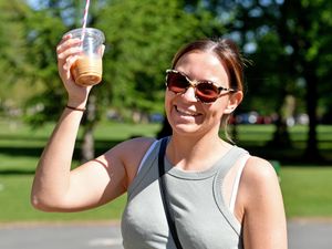 Ashleigh Hall cools off with a cold drink at Mary Stevens Park in Stourbridge. Photo: Tim Thursfield