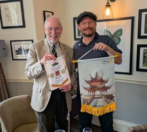 President Bill Rowell (L) exchanging club banners with Alex Boschell from the Hangzhou Rotary Club