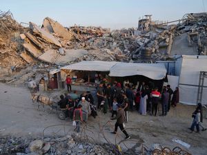 Palestinians walk amid the rubble of destroyed homes and buildings in Jabaliya in the northern Gaza Strip