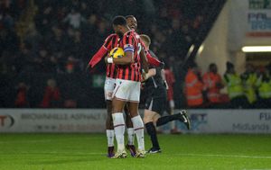 Daniel Kanu celebrates his equaliser with Jamille Matt during Walsall's defeat to Oldham.