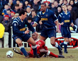 Liverpool's Michael Thomas on the ground as Shrewsbury's Steve Anthrobus (centre) comes in to collect the ball during today's match at Shrewsbury (PA)