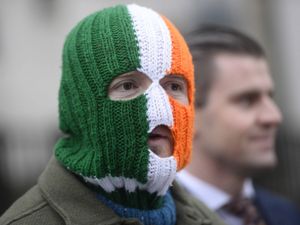 JJ O’Dochartaigh wearing an orange, white and green striped balaclava