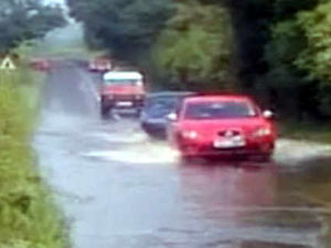 Supporting image for story: Cars tackle flooded roads