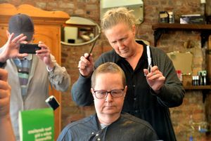 Pat Hirst having her head shaved to raise money for Macmillan Cancer Support. Doing the chopping was Jo Williams.