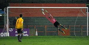 Ryan Young of AFC Telford United makes a save from a shot from Alberton Saidi of Workington