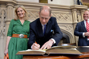 The Duke and Duchess sign their names in the visitors book