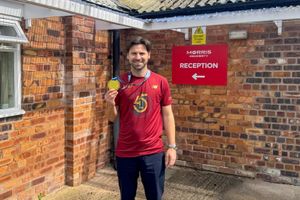 Senior Quantity Surveyor Alex Morris with his golden medal after the TCS London Marathon 2025