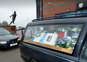 Floral tributes to Les can be seen in the hearse 
