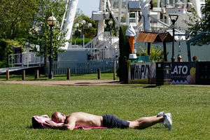 A man sunbathes in Stratford-upon-Avon, Warwickshire.