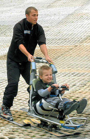 Jared Marple, six, of Priorslee, trying out a ski seat with the help of instructor Adam Harris at the Telford Ski Centre in Madeley