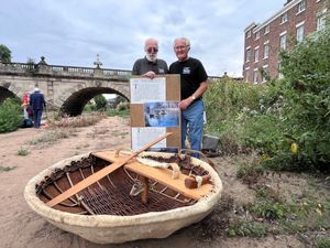 Master coracle makers Dave Purvis and Peter Falconer with Peter's Teme coracle on the banks of the River Severn in Shrewsbury