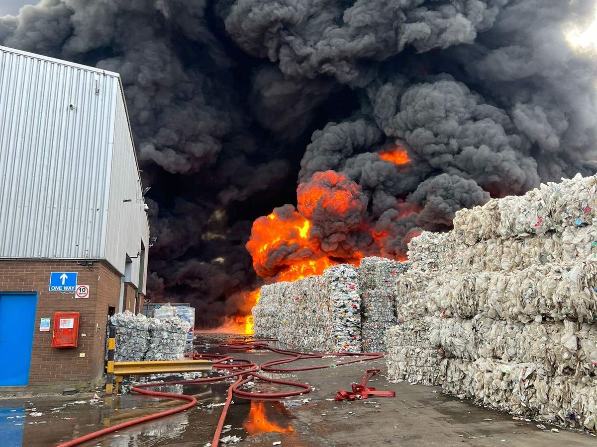 Black smoke seen as firefighters tackle large fire at recycling warehouse
