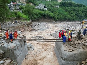 Supporting image for story: Search for missing after flooding and bridge collapse in China kill at least 25