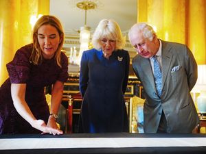 Dame Antonia Romeo presenting the King and Queen Camilla with the Coronation Roll