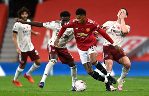 Manchester United's Marcus Rashford (centre) battles for the ball with Arsenal's Kieran Tierney (right) and Bukayo Saka