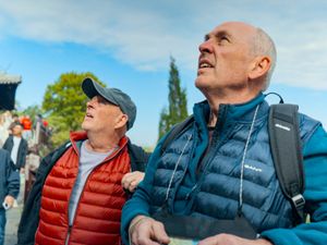 Two men looking up at something out of frame