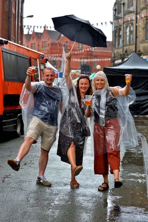 Braving the rain at Oswestry Food Festival on Saturday were Karolina Dobis, Matthew Mika and Anita Kirchen