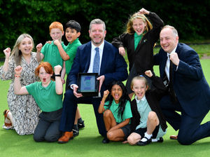 Headteacher Simon Arnold (centre) with fellow staff members senior leader Faye Billingsley and Deputy Headteacher Paul Lane celebrate with pupils after Oak Meadow Primary School was awarded Primary School of the Year 2023