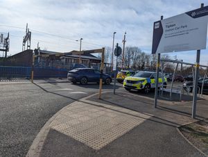 A number of police vehicles can be seen in the car park of Tipton Train Station