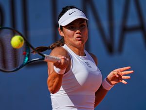 Emma Raducanu hits a forehand