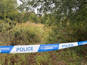 A police cordon is seen in the grassland off Tame Road, Oldbury