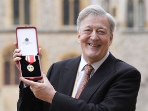 Sir Stephen Fry with his medal after being made a Knight Bachelor at Windsor Castle