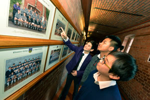 Adrian De-guel shows Mark Li and Ryan Xing the school’s photos
