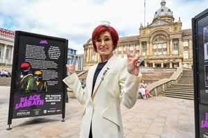 Sharon Osbourne looks at Black Sabbath album covers at the outdoor exhibition in Victoria Square, Birmingham