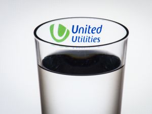 A glass of water with a logo inside