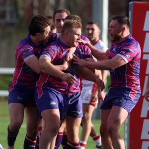 Brandon Moore is mobbed by teammates after scoring a try. Photo: Andy Shaw