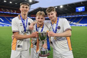 Karsten Cairns (left), Jack Loughran and Joe Morris of Shrewsbury Town celebrate with the Professional Development League Trophy