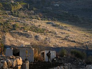 An Israeli soldier stands guard at a security fence near the so-called Alpha Line that separates the Israeli-annexed Golan Heights from Syria