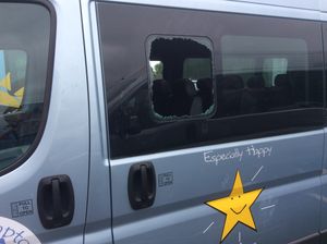A smashed window on one of the minibus