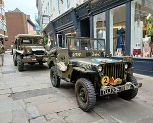Caption: The Jeep and Command Car parked in The Square, Shrewsbury.
