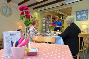 Lynne Bristow with customers in the cafe/tea shop area