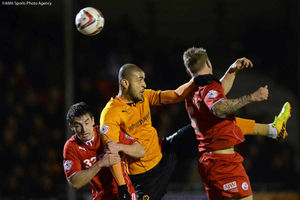 Leon Clarke of Wolverhampton Wanderers battles with Joe Walsh of Crawley Town and Kyle McFadzean of Crawley Town.