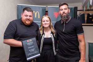 Joe Ledley (right) presents the award to Tom Leather and Courtney Ashworth of The New Saints FC Foundation.