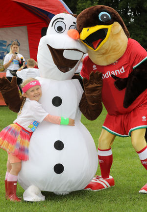 Isla Lester, aged six, with Olaf from Frozen and the Walsall FC mascot.