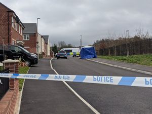 The police cordon remains in place at the scene where the teenager was found fatally injured