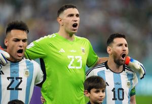 Argentina's Lionel Messi (right) singing the Argentinaian national anthem with Emiliano (centre) Martinez and Lautaro Martine